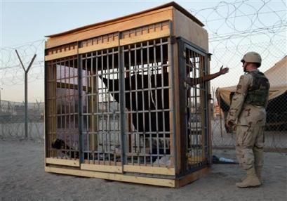 The Naked Man in Cage poked by Foreign Speaking Troops at 