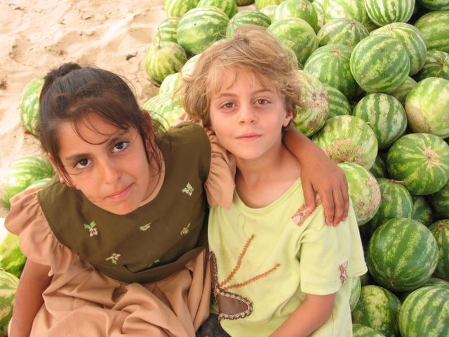 sisters_by_watermelons_their_father_sells_in_gaza.jpg 