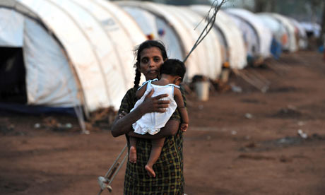 a_displaced_tamil_woman_holds_her_baby_at_a_refugee_camp_in_northern_sri_lanka.jpg 