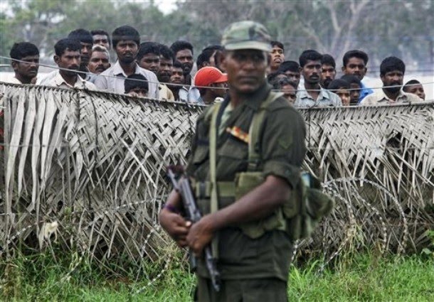 a_sri_lankan_army_soldier_stands_guard_next_to_a_fence.jpg 