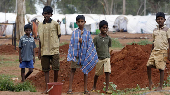 children_stand_in_front_of_razor_wire_at_the_manik_farm_displaced_persons_camp_in_vavuniya_in_sri_lanka.jpg 