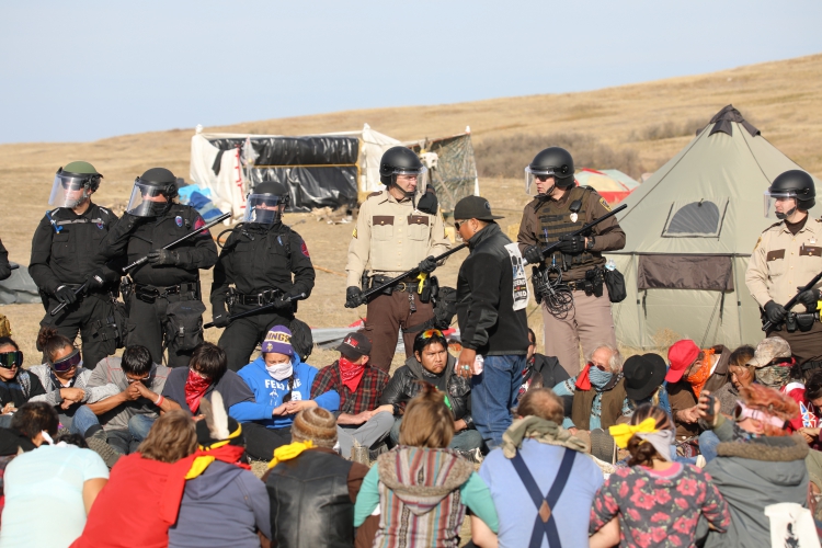 sm_standing_rock_prayer_circle_riot_police.jpg 