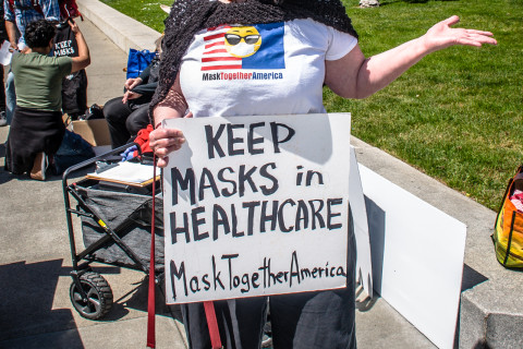 demonstrator in black mask and clothing