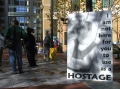 120_121002_oakfed_nowar_01_held_hostage_sign.jpg