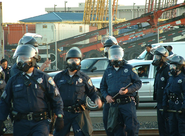 040703_antiwar_oakland_docks_opd_gasmaskpiggies.jpg 