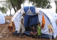 sri_lankan_ethnic_tamils_look_outside_their_tents_in_a_camp_for_internally_displaced_people_at_manik_farm_near_vavuniya.jpg 