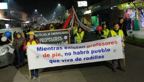 chile_teachers_protesters_holding_a_banner_that_reads_xas_long_as_teachers_stand_upx_the_people_will_not_be_on_their_kneesx_in_osornox_chilex_june_20x_2019_.jpg_1718483346.jpg 