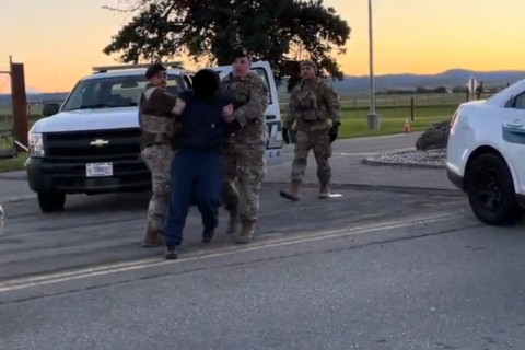 A protester at the Wheatland Gate getting dragged away by military police.