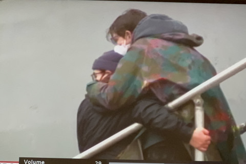 USNS Harvey Milk ship boarders holding each other
