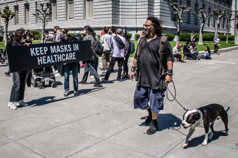 man with mean looking dog passes by demo