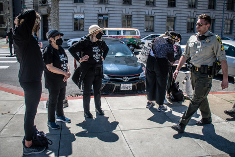 Sheriff Dept approaches demonstrators in Black T-shirts 