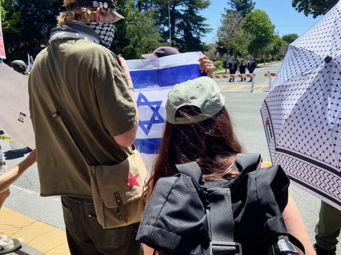 Israeli flag wielding counter demonstrator tries to block pro Palestine protesters