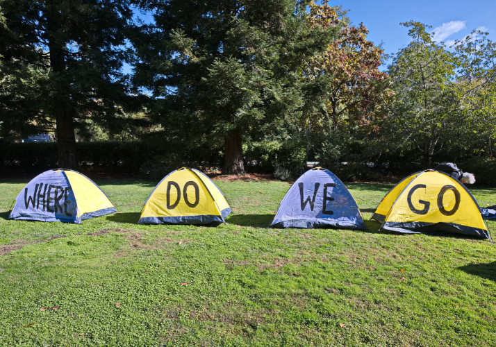 Wealthy well dressed people get to see a pretend homeless encampment. In their understated quality casual clothes, some well meaning peo...