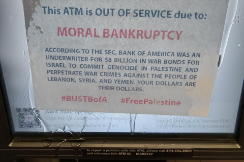 A close up of a piece of paper clear epoxied to the screen of an ATM.