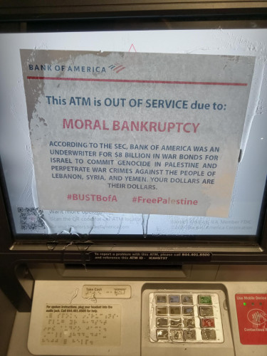 A close up of a piece of paper clear epoxied to the screen of an ATM.