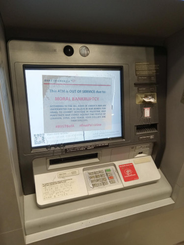 A photo of a BoA ATM that has a message epoxied to its screen. The card reader and keys have been disabled with epoxy as well.
