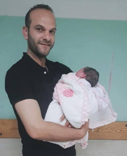 Palestinian doctor Fadi Ali Al-Bayoumi and his two-month-old child