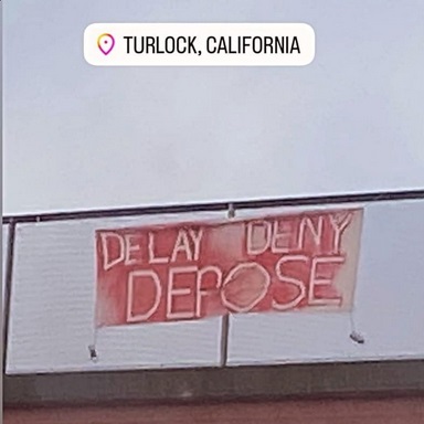 Photo of a banner dropped in Turlock, CA.