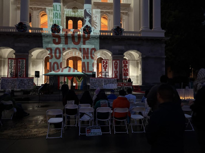 The slogan "Stop Bombing Hospitals" was projected onto the Capitol. Photo by Dan Bacher.