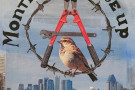 Montreal 4 Riseup featuring a "Circle A" made of barbwire and bolt cutters with a bird on the wire.