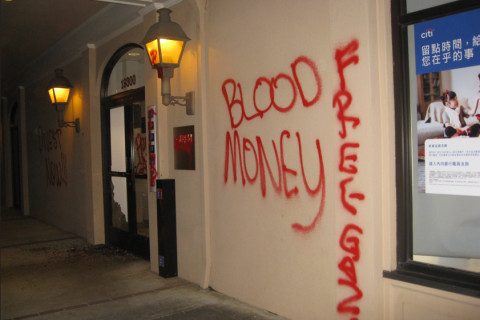 citibank office front vandalized with words "BLOOD MONEY" and "FREE GAZA" spray painted in red.