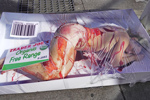An activist covered in fake blood lies in a “human meat” display outside Trader Joe’s in Berkeley on March 1st, 2025, as protestors insid...