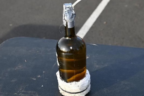 Photograph of recovered unlit molotov cocktail at Tesla dealership in Salem, Massachusetts
