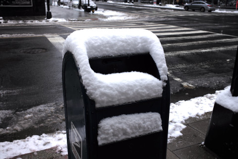A snow encrusted mailbox.