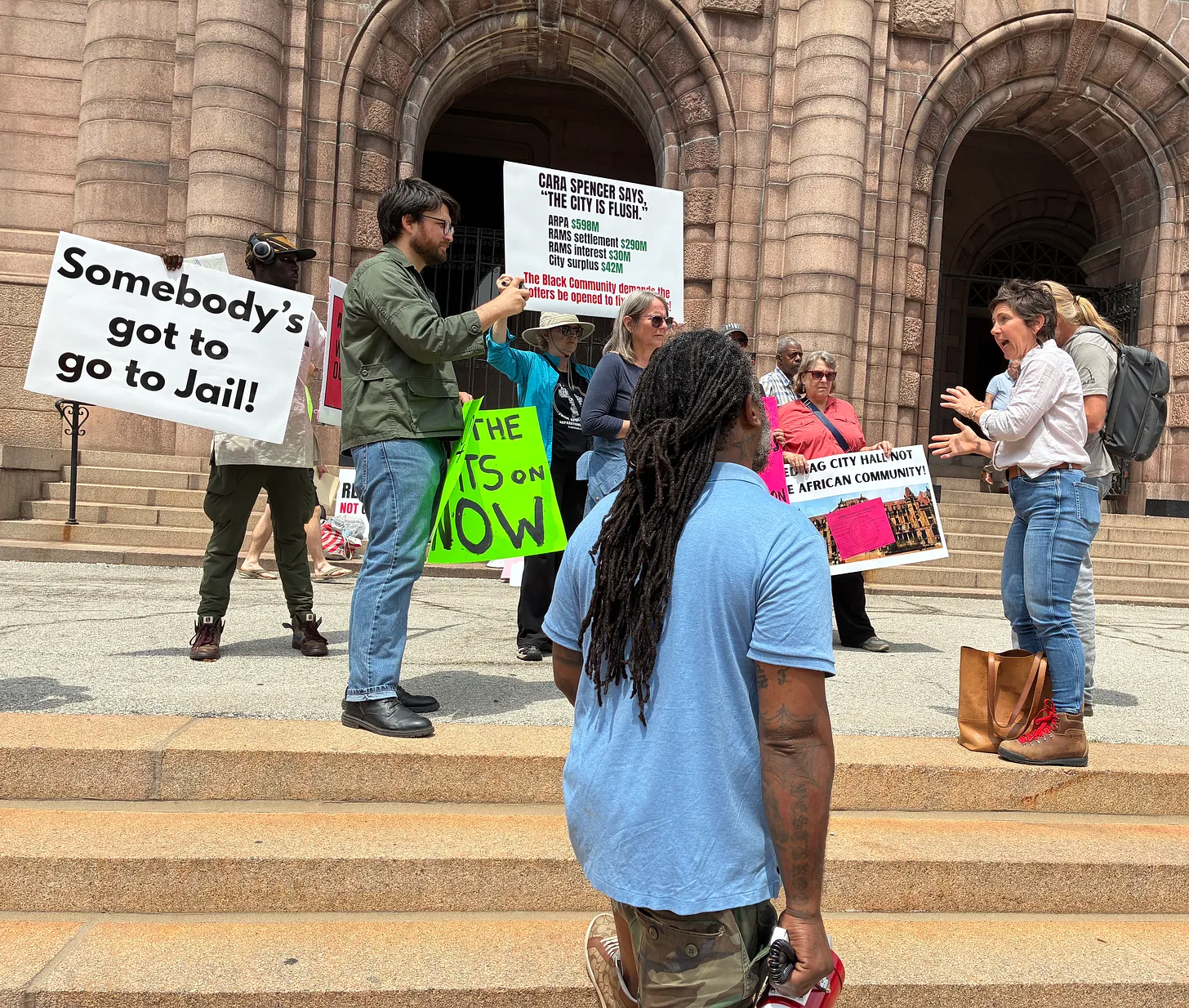 Protestors confront Mayor Cara Spencer (right) after power is cut off throughout Northside black community