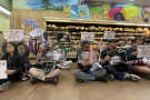 Protesters with signs sat in front of the chicken bodies inside the store for just over 30 minutes, while playing a recording of chickens...