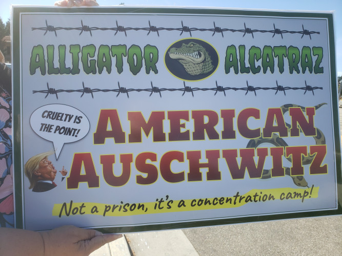 Sign that says Alligator Alcatraz (is) America's Auschwitz