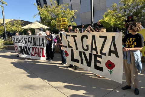 Banners at the rally outside the hotel