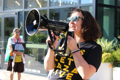 Leading the chants at the public rally in DOCO Plaza 