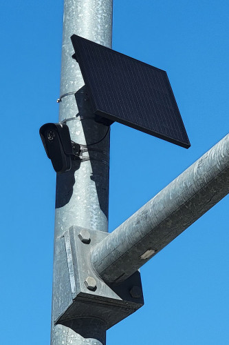photograph of flock camera and solar panel strapped to metal street pole