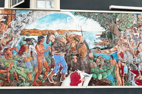 An overview of the offending mural with amendments of arrows piercing colonizers