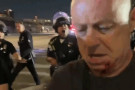 Photo: An LAPD officer assaulted photojournalist Nick Stern (foreground) after he held up his LA Press Club press pass (Screenshot taken ...