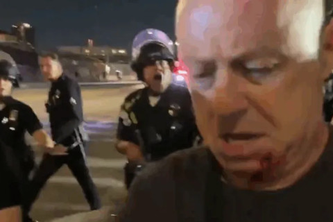 Photo: An LAPD officer assaulted photojournalist Nick Stern (foreground) after he held up his LA Press Club press pass (Screenshot taken ...