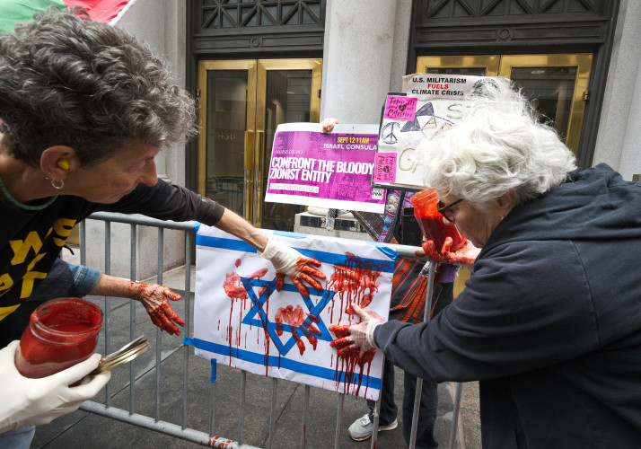 A look they did not intend as 'blood' is hosed off the sidewalk
