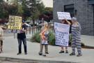 Protestors holding signs from the Monday demonstration