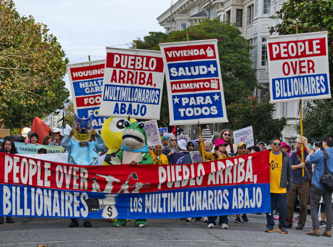 Frogs, an octopus, a squid, a school of orcas and activists bring their "People Over Billionaires" demands to the ultra wealthy in colorf...