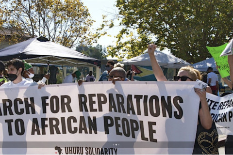 White people marching in support of reparations to Africa people