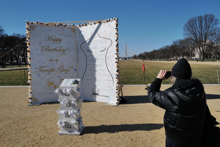Located on the National Mall near the Capitol, the Trump birthday card for Jeffrey Epstein, is overseen by a massive two-story scowling T...