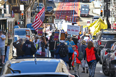 Activists of all ages rally with speeches, costumes, and march