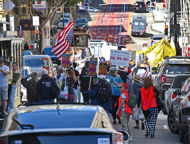 Activists of all ages rally with speeches, costumes, and march