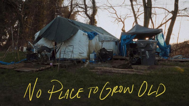 A shelter that has been pieced together from tarps and other materials. Overlaid is the text "No Place to Grow Old."
