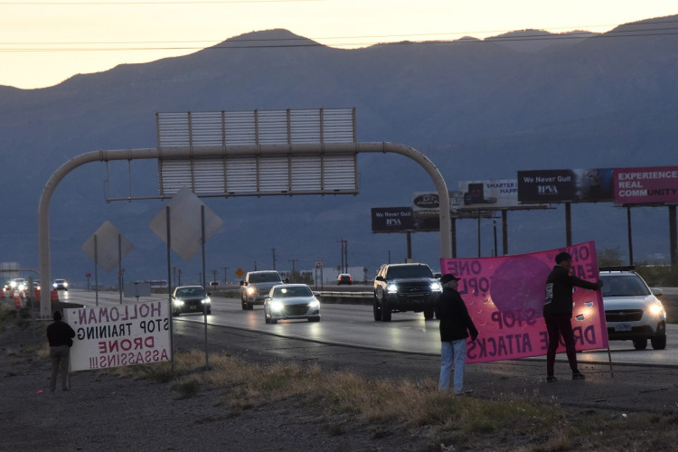 Activists holding banners against drone attacks