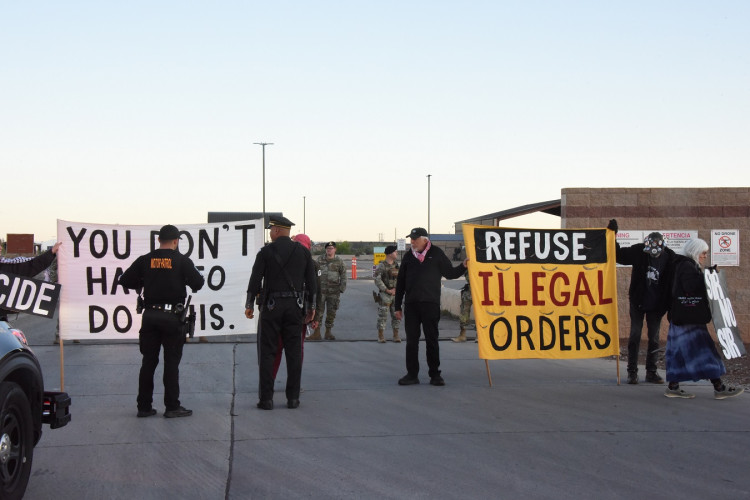 State troopers and military police confronting protesters in gate