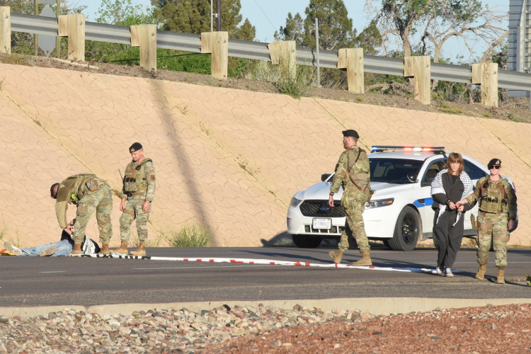 Military police arresting protesters in roadway