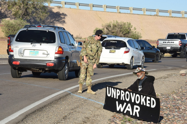 Activist holding a sign against unprovoked war
