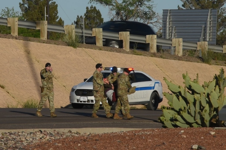 Military police arresting protester in roadway